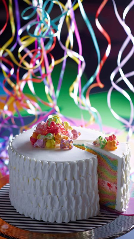 a birthday cake is surrounded by confetti and colorful balloons.  AI-Generated 33760394 Stock Photo at Vecteezy